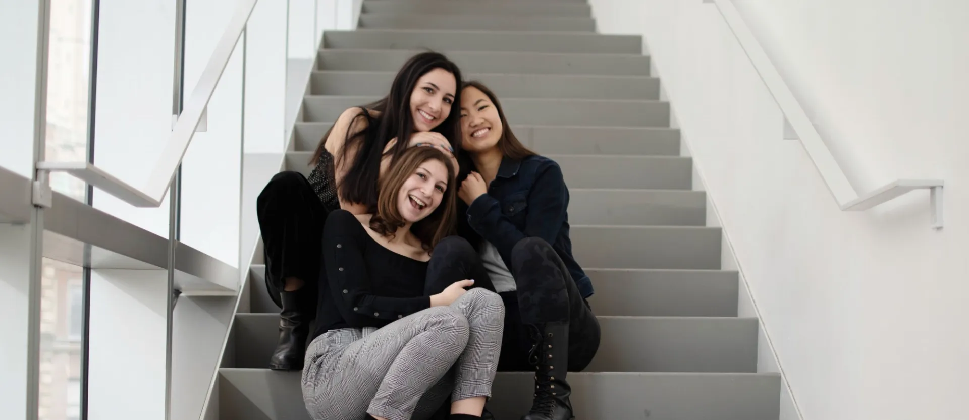 Orchesis Executive Board 2019 posing together on steps. 