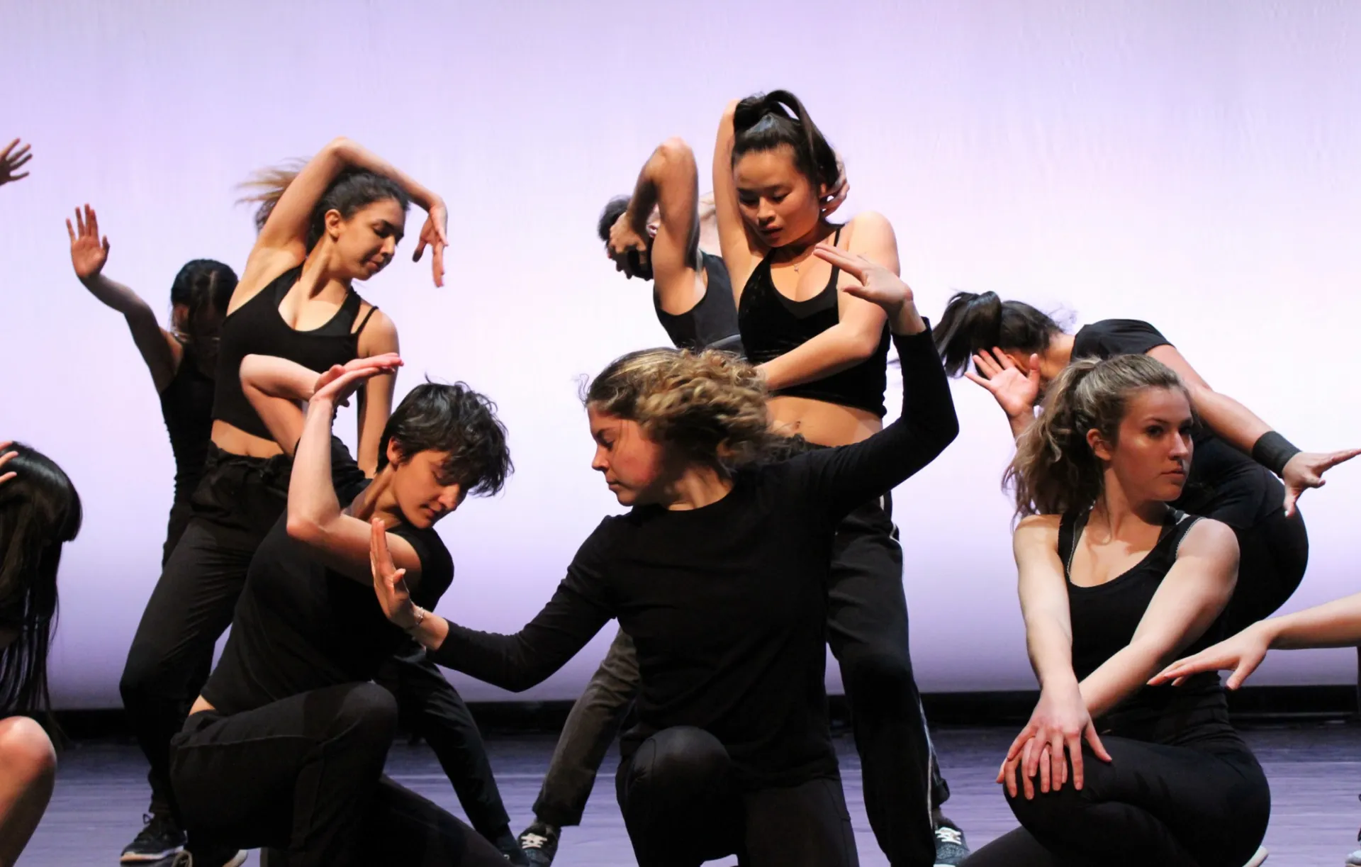 Dancers from our Spring 2019 show performing choreography by Chris Lee onstage.
